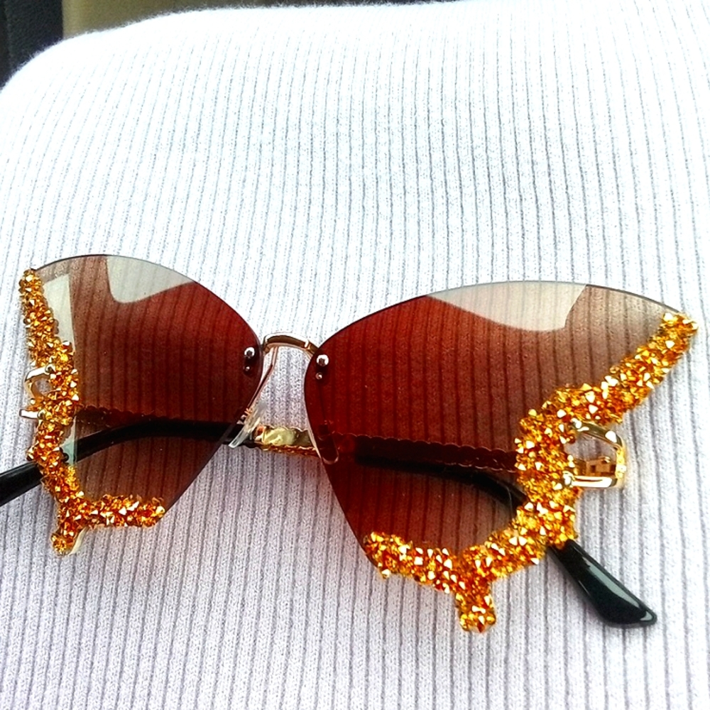 Golden and black womans butterfly sunglasses.
